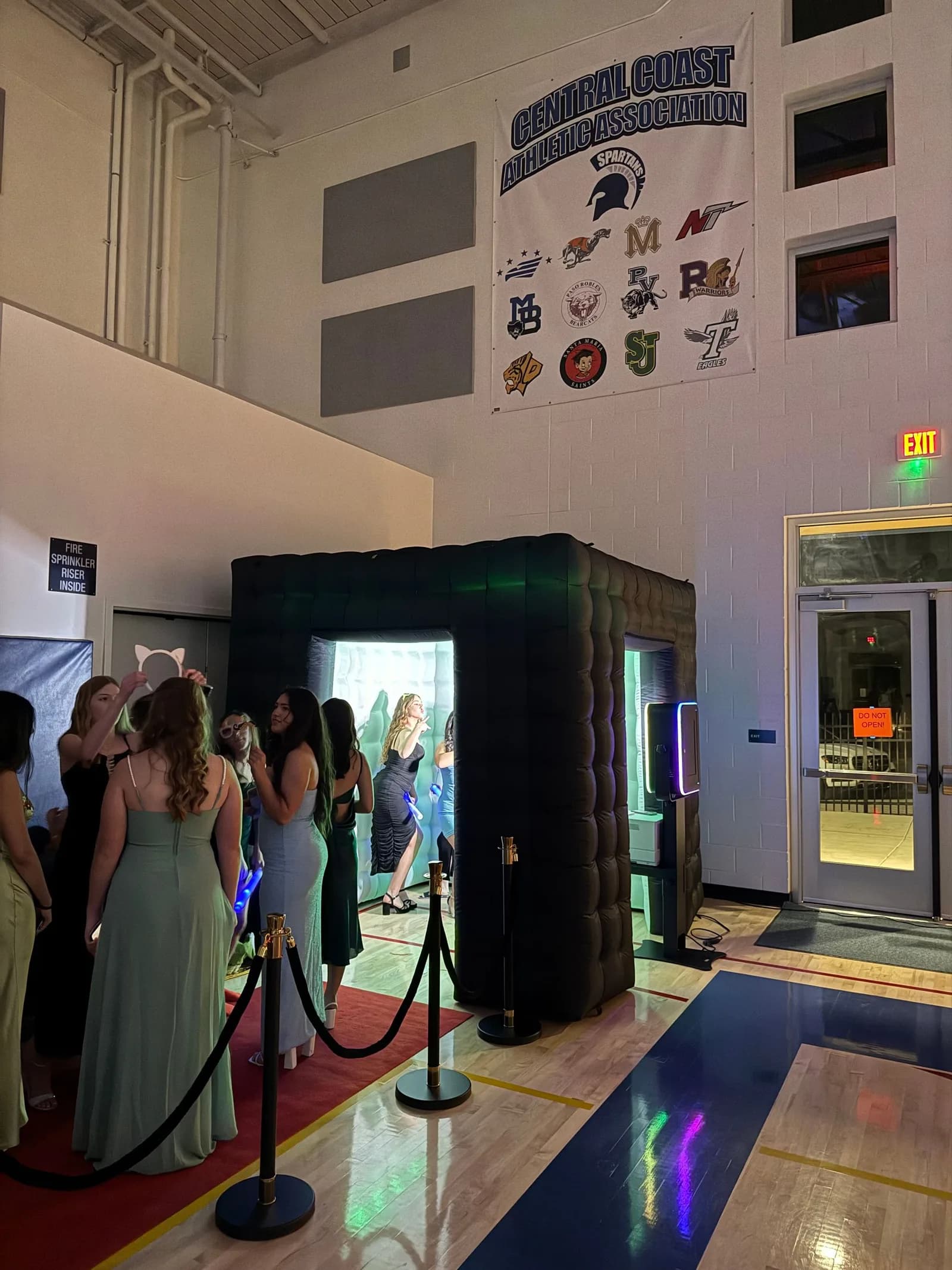 Guests entering the enclosed photo booth at a prom