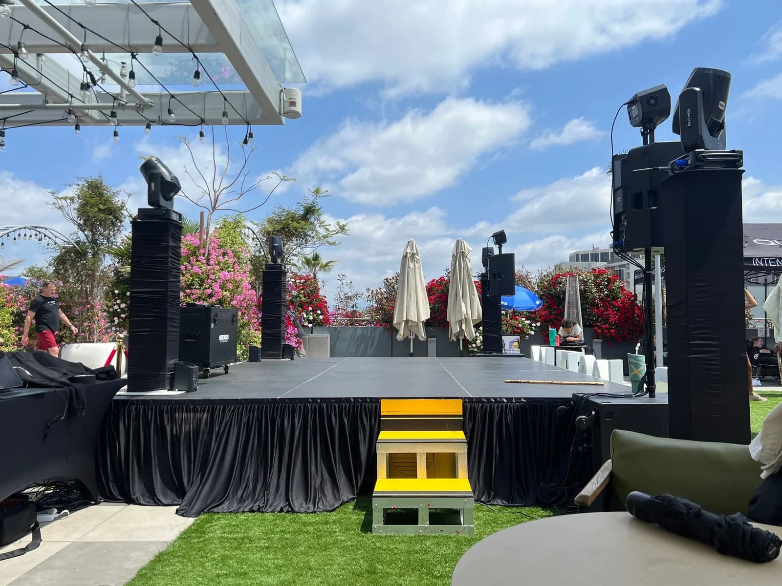 Outdoor stage with speakers and moving-head lighting