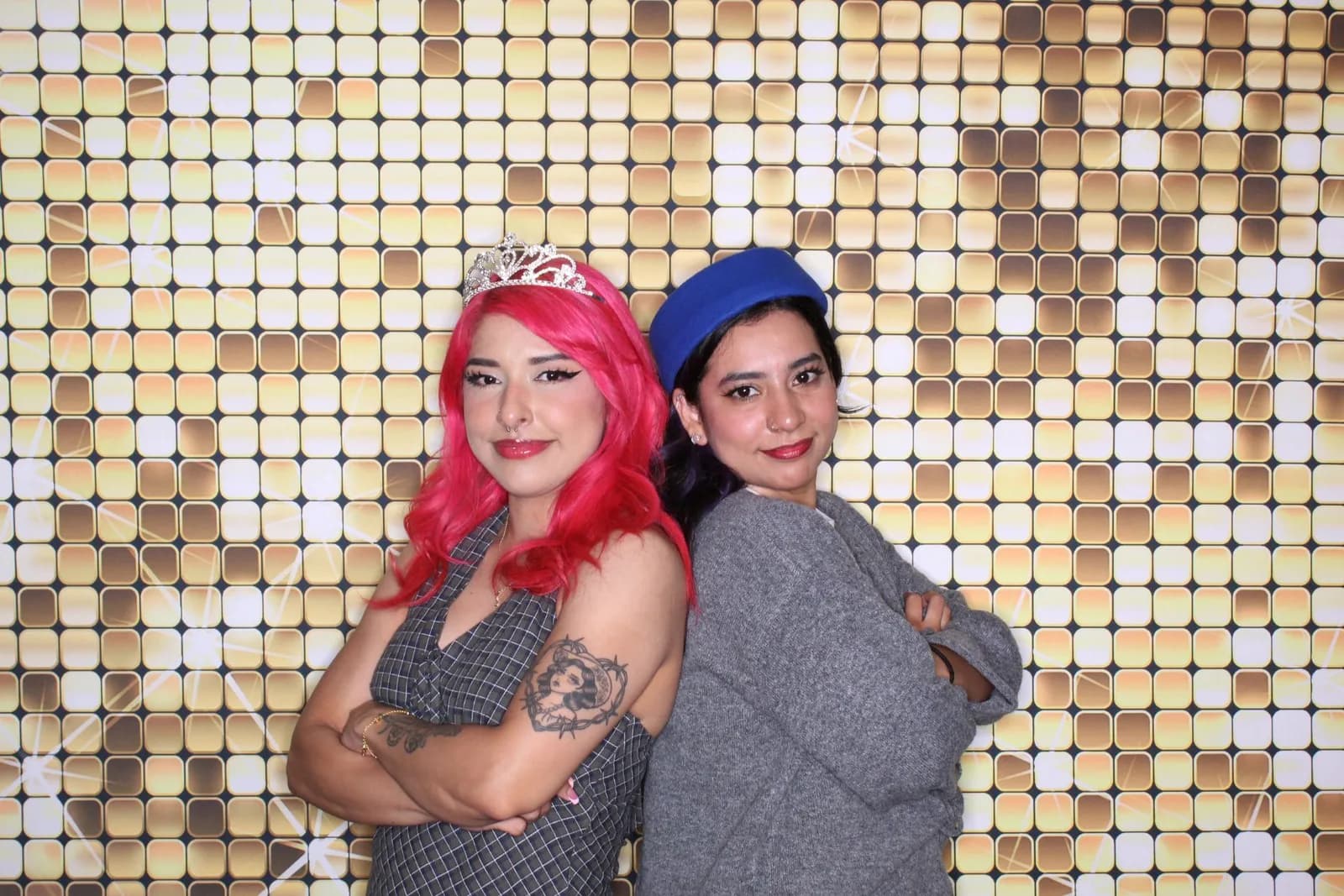 Guests at gold shimmer wall wedding photo booth