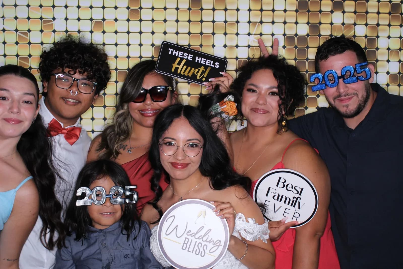 Wedding guests with props at the photo booth