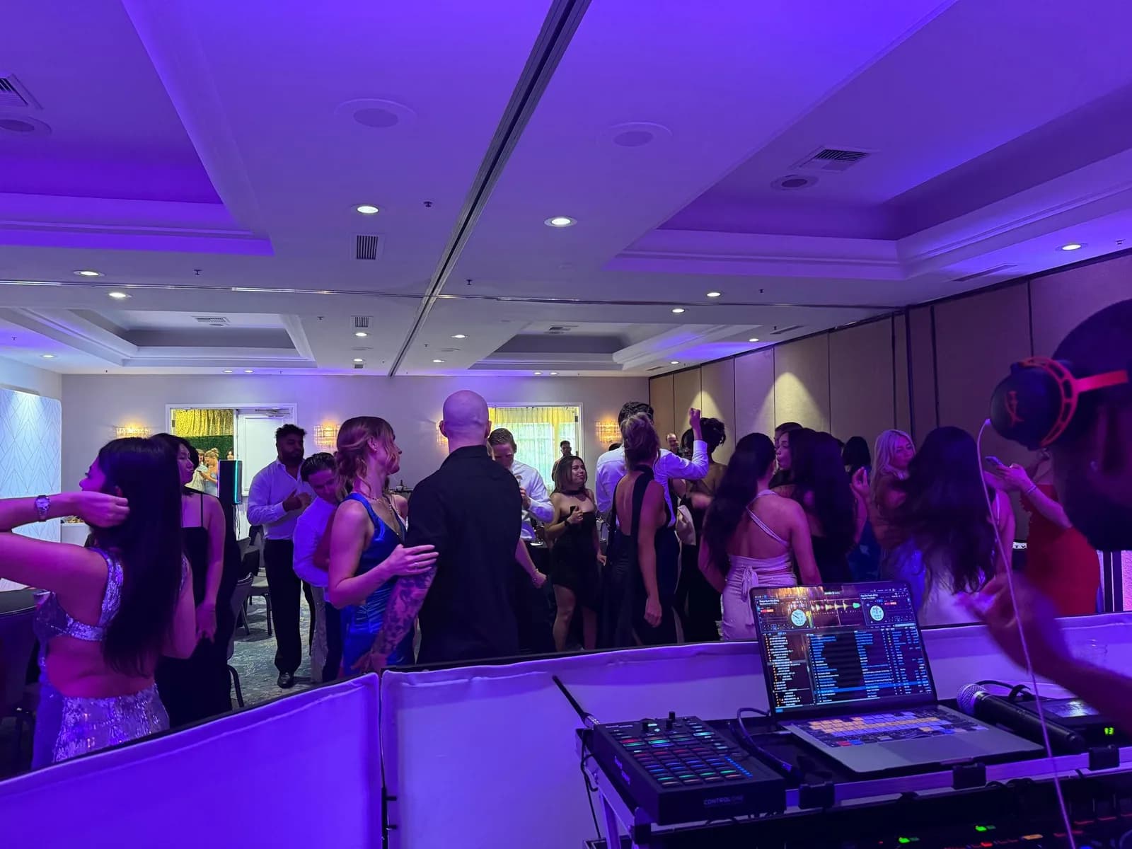 Prom with purple uplighting and DJ