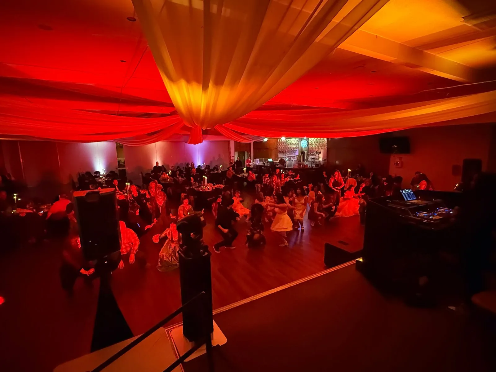 Quinceañera ballroom with red uplighting and DJ sound