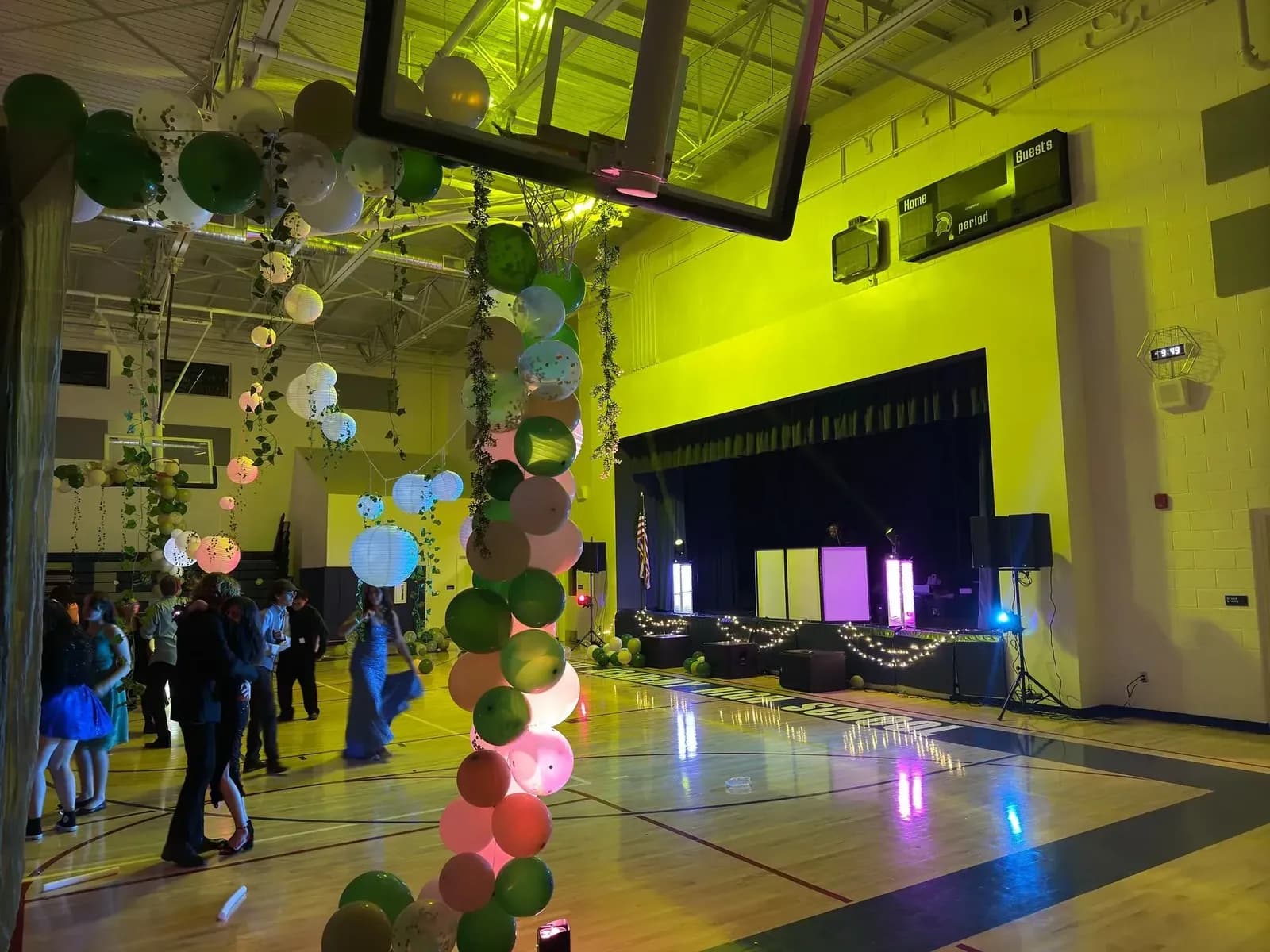 School dance with DJ in a decorated gym
