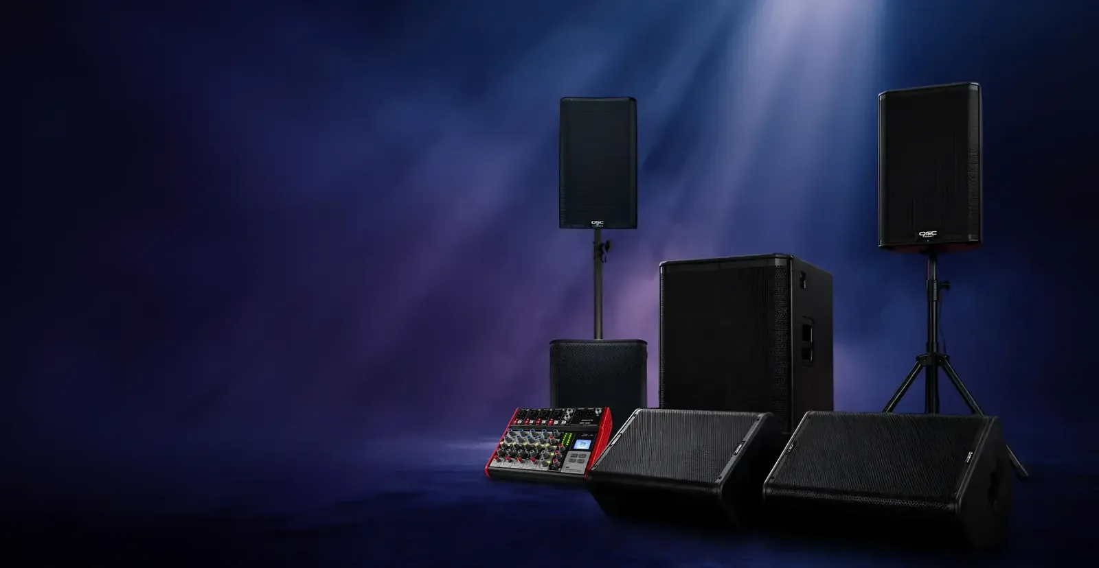 Professional QSC speaker stack and subwoofers ready for an event